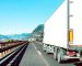 Semi truck speeding on empty highway line - Transport logistic concept with semitruck container driving on speedway - Focus on central part of background